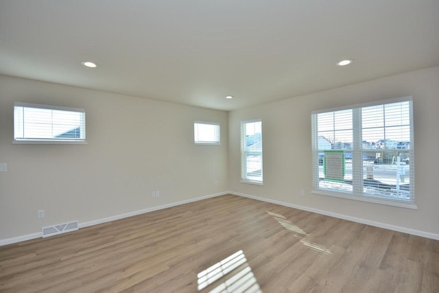 spare room with light wood-type flooring