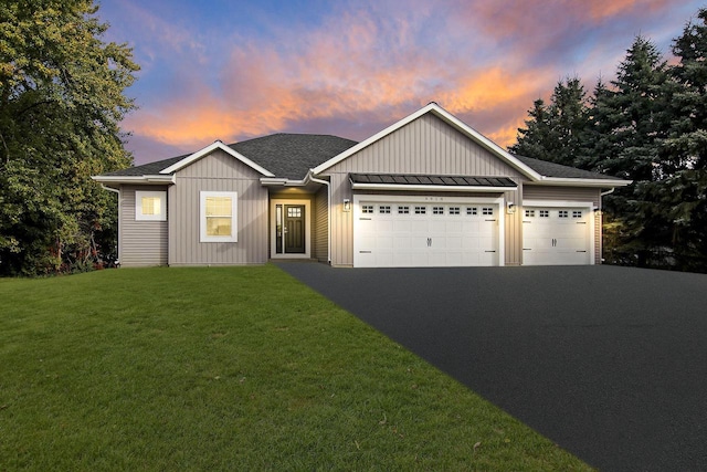 view of front of house with a yard and a garage