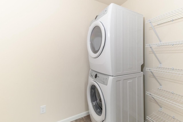 washroom with stacked washer and clothes dryer