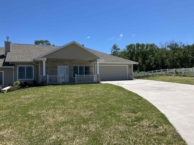 single story home with a porch, a front lawn, and a garage