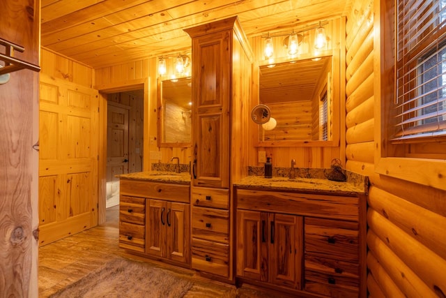 bathroom featuring vanity, wood ceiling, wood-type flooring, and rustic walls