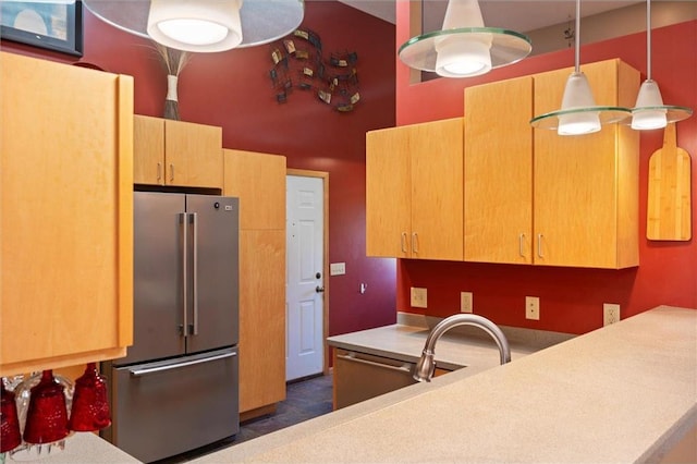 kitchen featuring high end fridge and decorative light fixtures