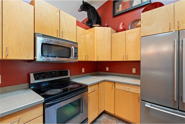 kitchen featuring light brown cabinets and stainless steel appliances