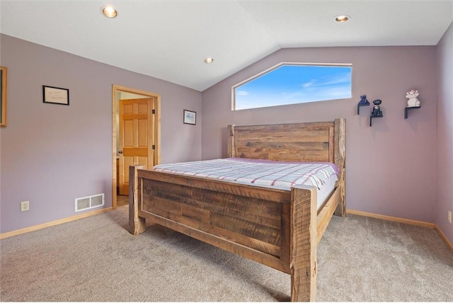 bedroom with light carpet and lofted ceiling