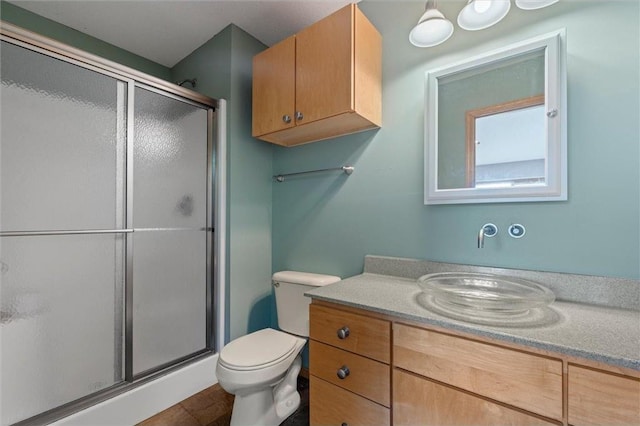 bathroom with toilet, an enclosed shower, vanity, and tile patterned floors