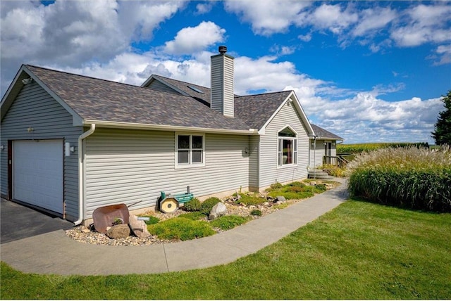 811 130th St, Roberts, WI 54023 - view of side of property with a shingled roof, a chimney, a lawn, and an attached garage