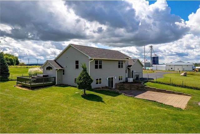 811 130th St, Roberts, WI 54023 - rear view of property with a yard, fence, central air condition unit, and a deck