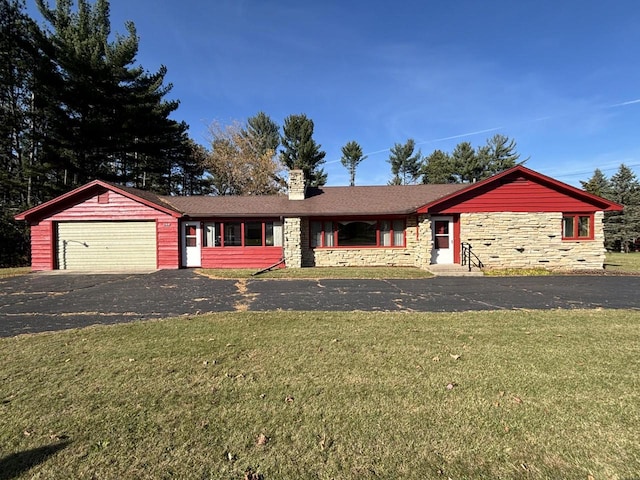 ranch-style house featuring a garage and a front lawn