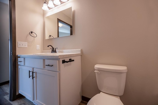 bathroom featuring vanity and toilet