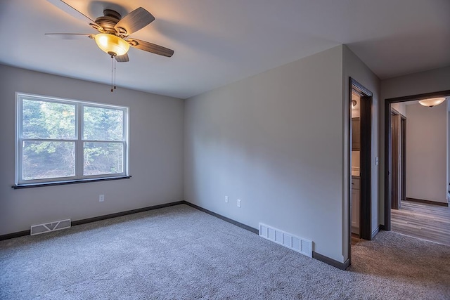 empty room with ceiling fan and carpet