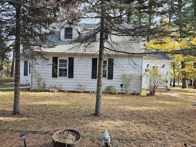 view of side of home with a lawn