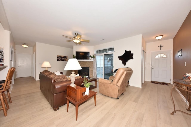 living room featuring light hardwood / wood-style floors and ceiling fan