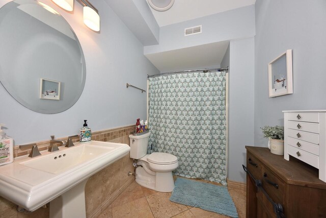 bathroom featuring toilet and tile patterned floors