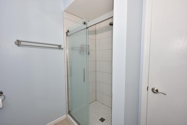 bathroom with a shower with shower door