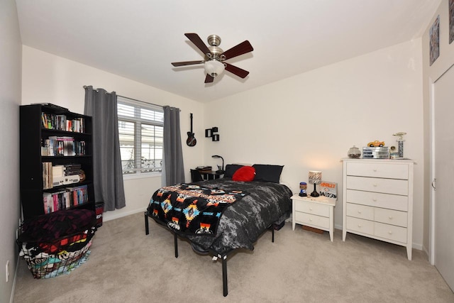 bedroom featuring light colored carpet and ceiling fan