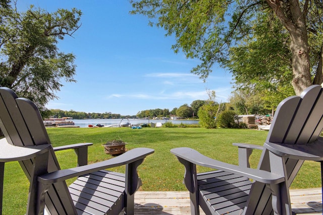 view of yard with a water view and a fire pit