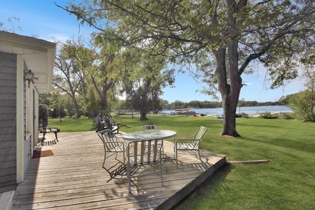 wooden terrace featuring a lawn and a water view