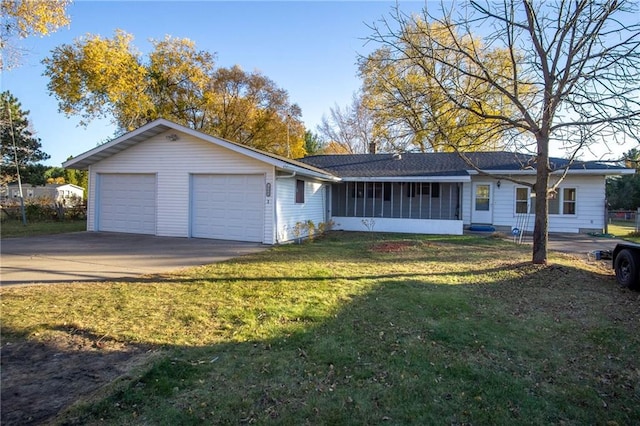 ranch-style home featuring a front yard, a garage, and a sunroom