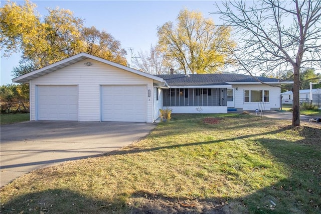 ranch-style home featuring a sunroom, a front lawn, and a garage