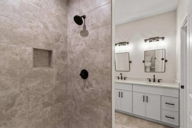 bathroom featuring vanity and a tile shower