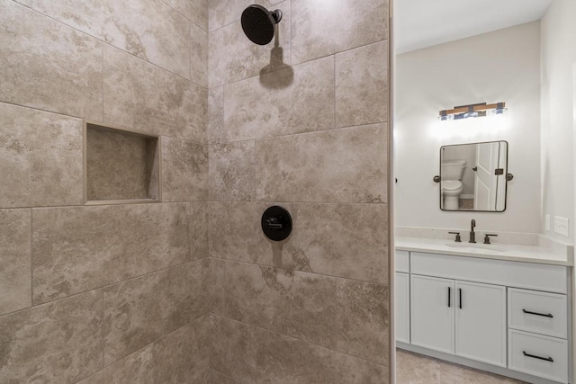 bathroom featuring vanity and a tile shower