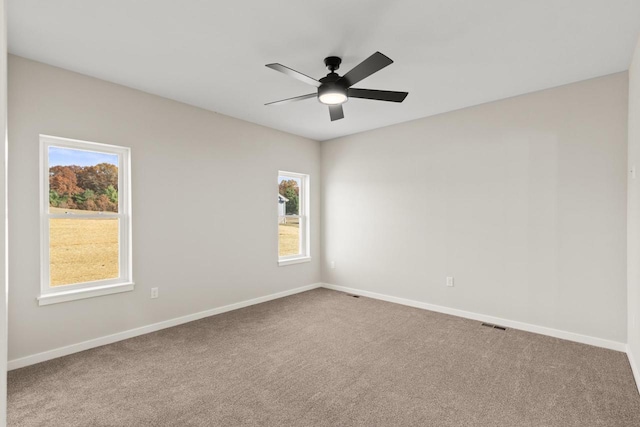 spare room with carpet and ceiling fan