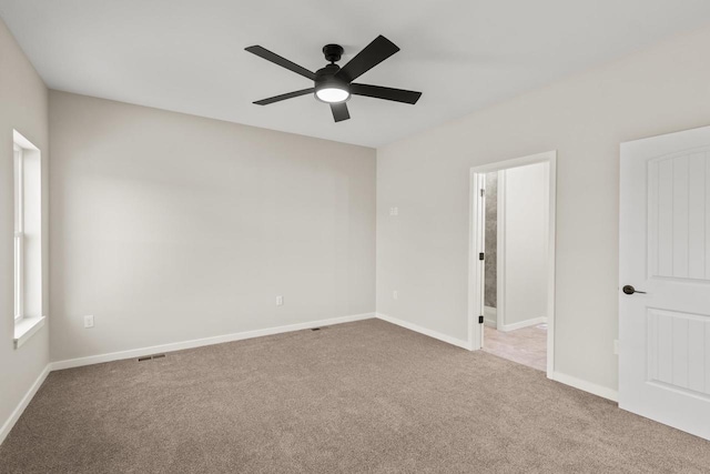 carpeted empty room featuring ceiling fan