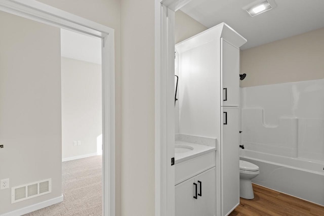 full bathroom with vanity, toilet, wood-type flooring, and tub / shower combination