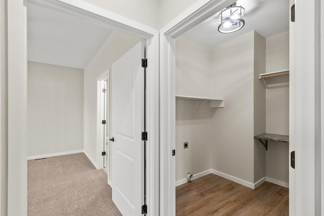 washroom with electric dryer hookup and light wood-type flooring