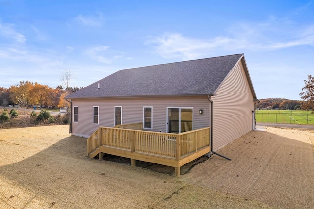 back of house featuring a wooden deck