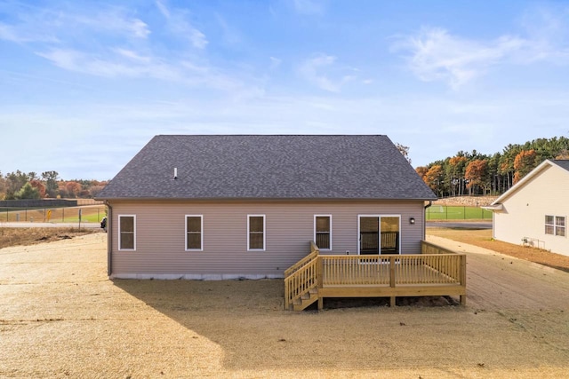 rear view of property featuring a wooden deck