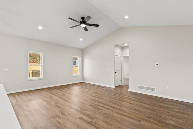 unfurnished living room featuring hardwood / wood-style floors, ceiling fan, and vaulted ceiling