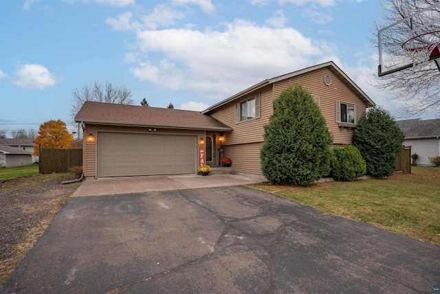 tri-level home featuring a front lawn and a garage