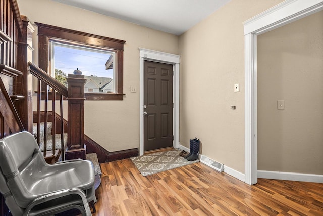 entryway with hardwood / wood-style flooring