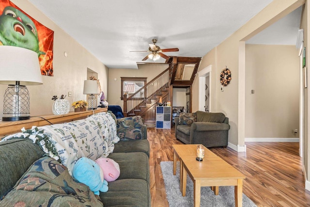 living room featuring hardwood / wood-style flooring and ceiling fan