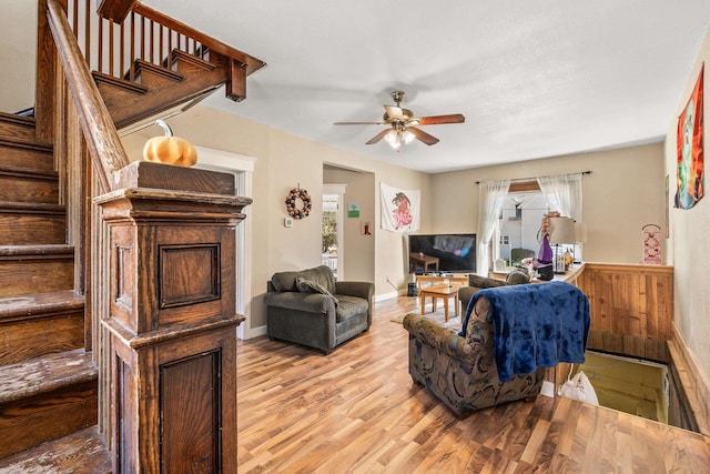 living room with ceiling fan and light wood-type flooring