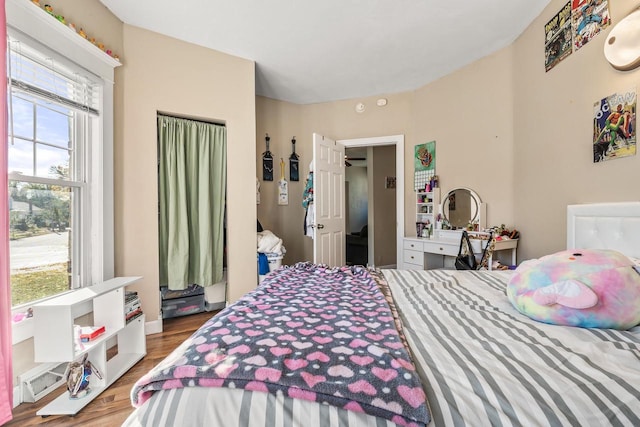 bedroom featuring hardwood / wood-style flooring and multiple windows