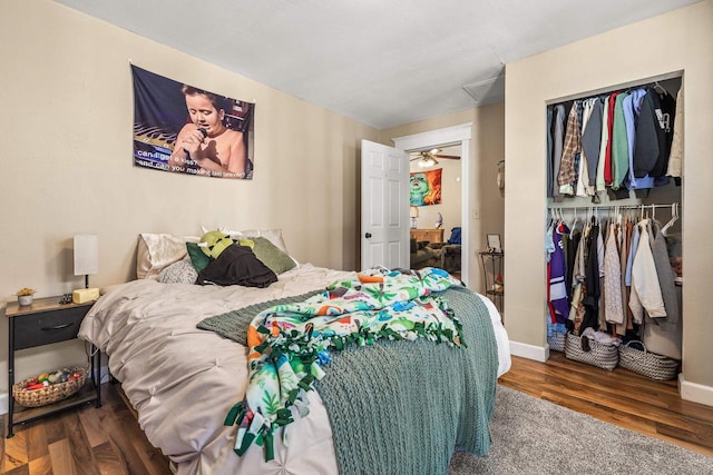 bedroom with dark wood-type flooring and a closet