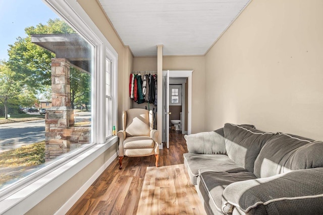 living room with ornamental molding, hardwood / wood-style floors, and a healthy amount of sunlight