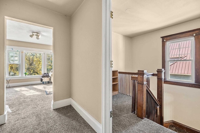 corridor featuring dark colored carpet