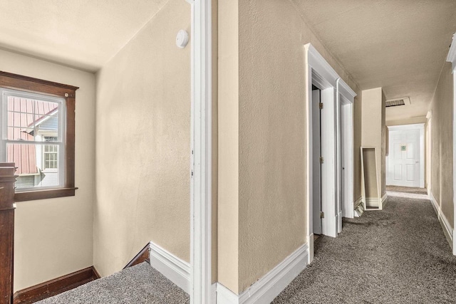 corridor with dark carpet