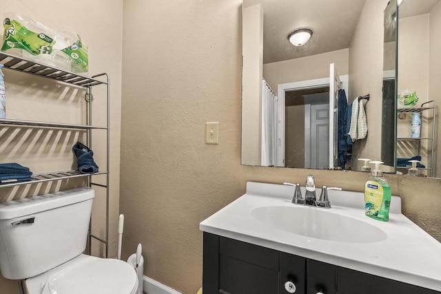 bathroom with toilet and vanity