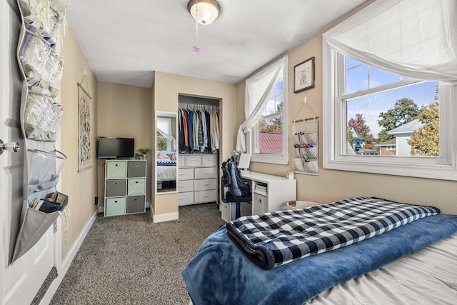 bedroom featuring dark colored carpet and a closet