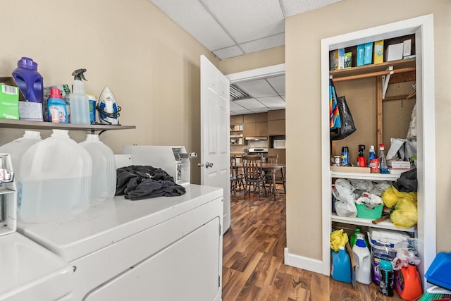 clothes washing area with washer and clothes dryer and dark hardwood / wood-style floors