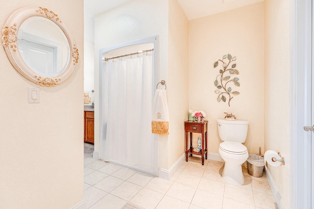 bathroom featuring vanity, tile patterned floors, and toilet