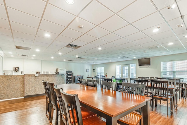 dining room with a wealth of natural light and light hardwood / wood-style flooring