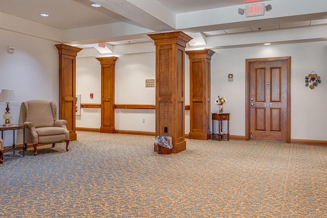 interior space featuring beamed ceiling, ornate columns, and carpet floors