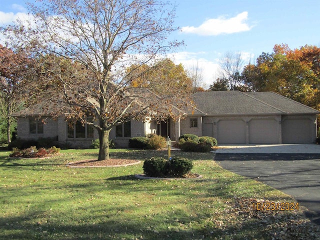 view of front of house with a garage and a front lawn