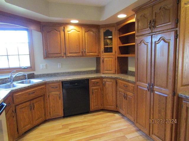 kitchen with light hardwood / wood-style floors, black dishwasher, and sink