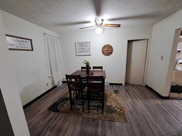 dining area with ceiling fan, dark hardwood / wood-style floors, and a textured ceiling